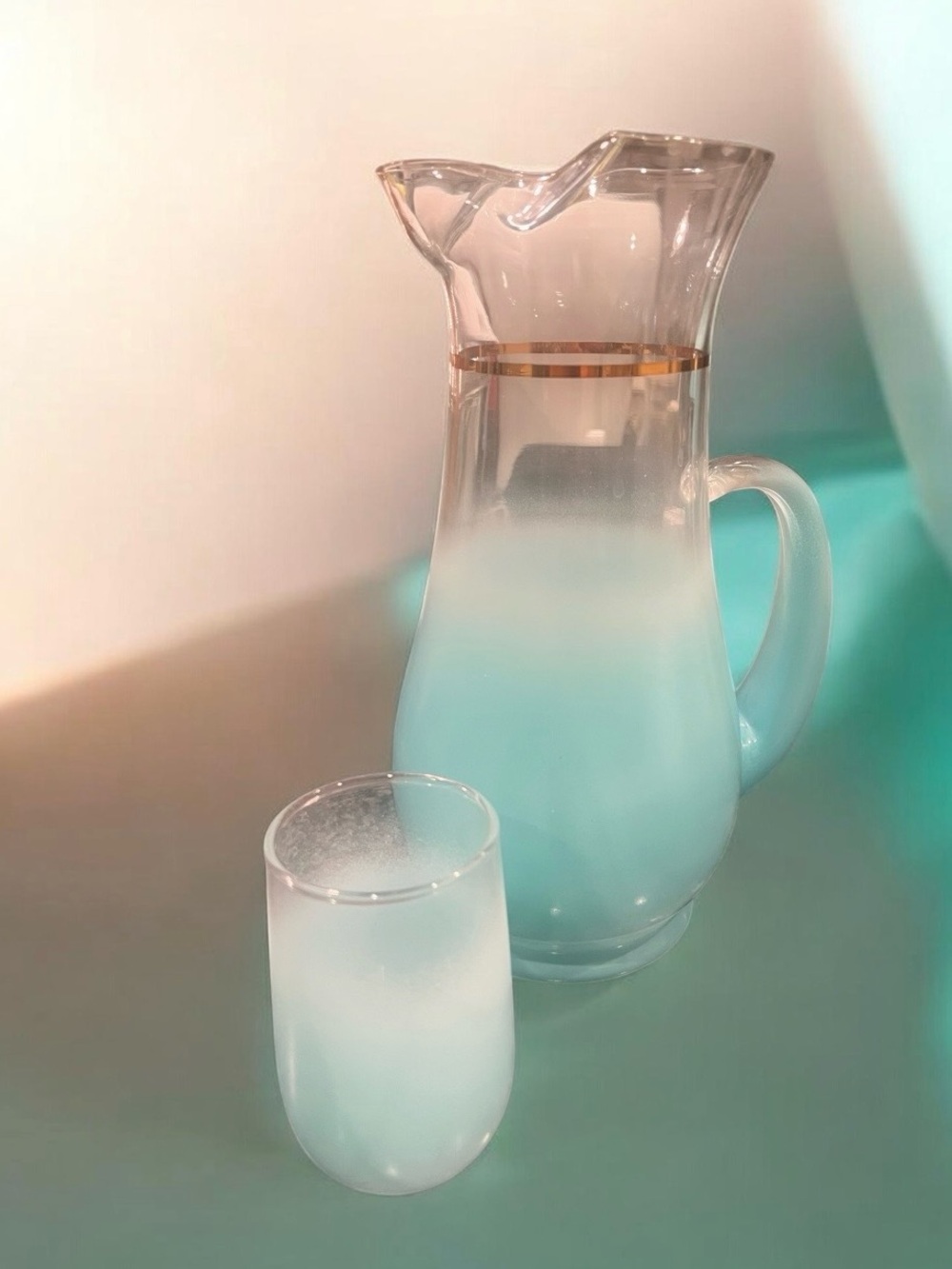 1960s Blendo frosted turquoise pitcher with gold band and matching glass.
